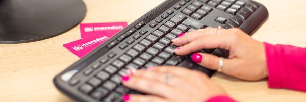 Marsden colleague on laptop browsing list of FAQs to help a customer