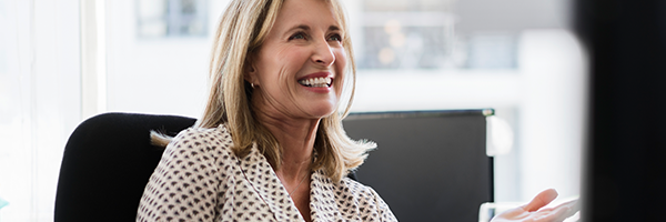 Business owner smiling in a work meeting after opening a business savings account with Marsden Building Society