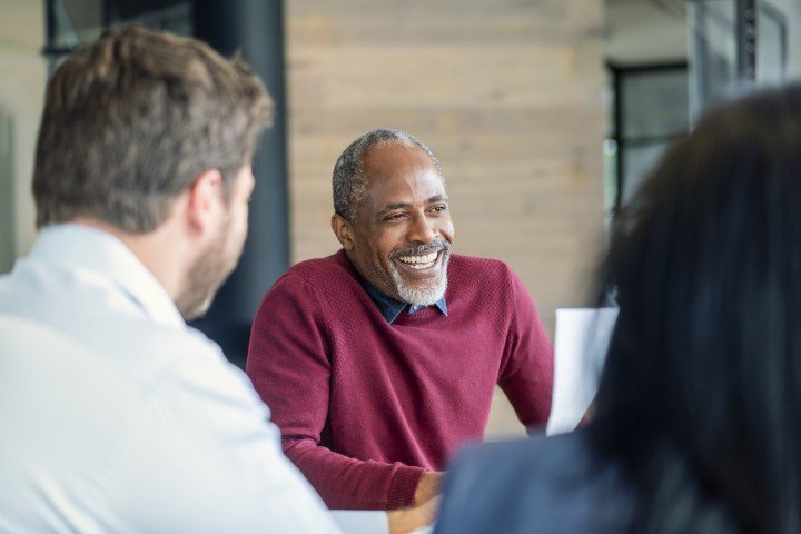 Professional man smiling in a business meeting about a partnership with Marsden Building Society