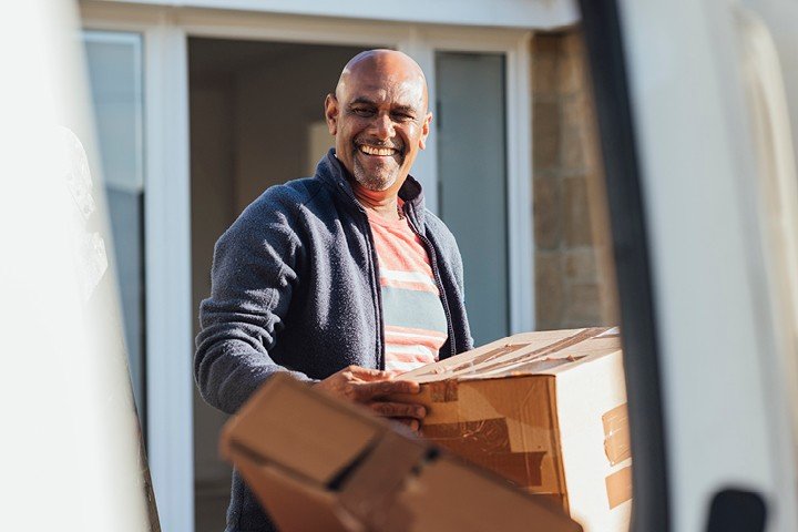 Holiday let landlord moves furniture into his new buy to let property after finding a mortgage through Mortgage Advice Bureau